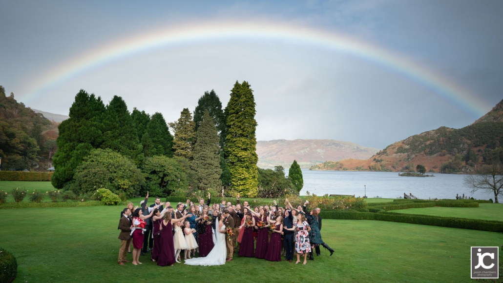 Wedding group photograph with a rainbow